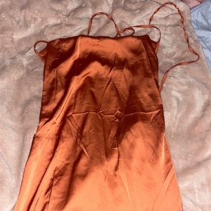 Rust orange dress very shape fitting.